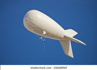 White dirigible in the cloudless sky