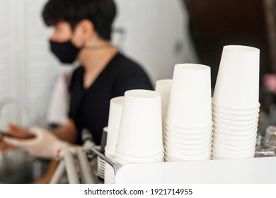 A Lot Of White Disposable Paper Cups On Coffee Machine With Cofe Shop Background. The Stack Of Paper Cup In The Cafe. Close Up Recycle White Paper Cups On Coffee Machine