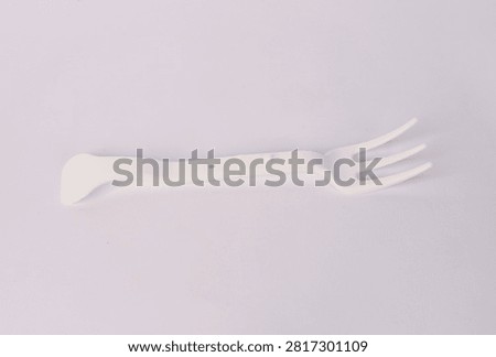  White disposable plastic fork with three tines isolated on white background
                              