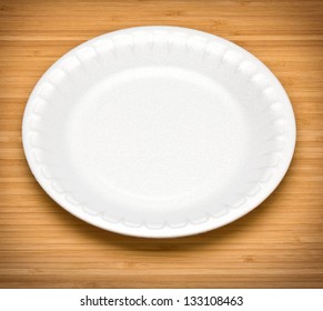 White Disposable Plates On A Wooden Table