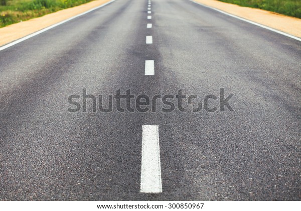 White\
dividing line on the road surface with the\
roadside
