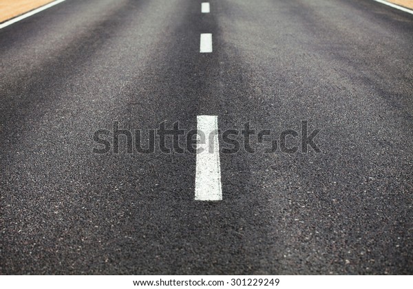 White\
dividing line on the road surface with the\
roadside