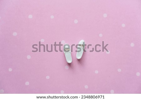 White doll shoes on a pink background. High quality photo