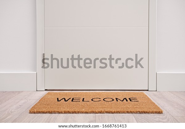 White door with a welcome\
mat