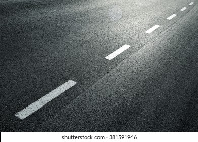 White Dotted Line On City Asphalt Road Background.