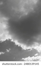 White dramatic clouds in the dark sky, black and white