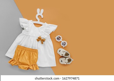 White Dress,  Orange Shorts With Kids Shoes And Sunglasses. Set Of  Baby Clothes And Accessories For Spring Or Summer . Fashion Childs Outfit. Flat Lay, Top View