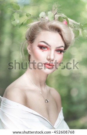 White dressed woman in the green forest
