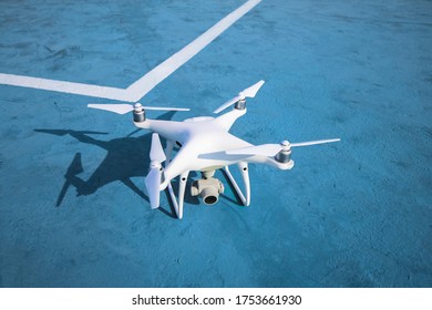 

White drone with camera
Lay on the ground