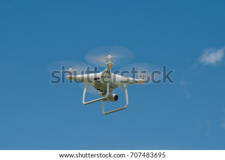 white drone hovering in a bright blue sky, Radio control helicopter