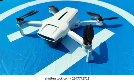 A white drone lands on a blue landing pad in the Cikancung area, Indonesia