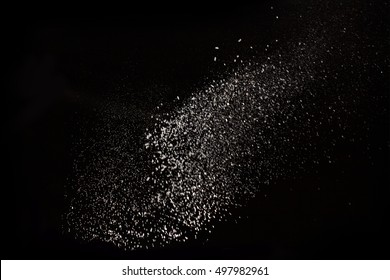 White Dust Debris Isolated On Black Background, Motion Powder Spray Burst In Dark Texture