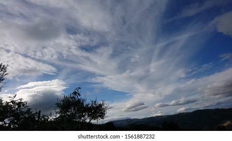 White dynamic clouds drawn on blue sky