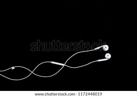 white earphone for listening music on black background