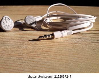 white earphones placed on the table