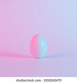 White Easter egg and colorful ultraviolet holographic neon lights  Creative concept 