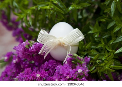 White easter eggs with golden bow with flowers