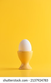 White Egg On Yellow Background