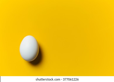 White egg on the yellow background. Design, visual art, minimalism - Powered by Shutterstock