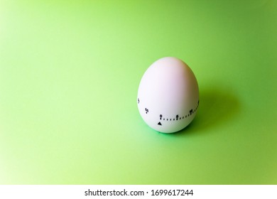 White Egg Timer On Green Background. Happy Easter In The Kitchen. Home Related, Home Staying. Free Copy Space. Flat Lay, Top View