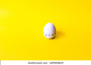 White Egg Timer On Yellow Background. Happy Easter In The Kitchen. Home Related, Home Staying. Free Copy Space. Flat Lay, Top View. Banner