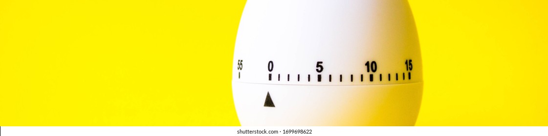 White Egg Timer On Yellow Background. Happy Easter In The Kitchen. Home Related, Home Staying. Free Copy Space. Flat Lay, Top View. Banner