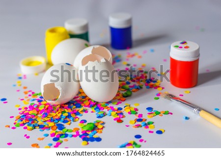 White eggshells with colorful paints and confetti for the traditional latin american holiday carnaval celebrated in March. 