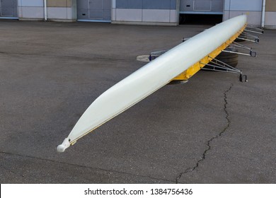 White Eight Sweep Rowing Boat Drying In Upside Down Position At Canal Shore On Gray Background With Copy Space