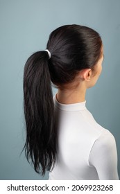 A White Elastic Band Is Tied On The Girl's Hair