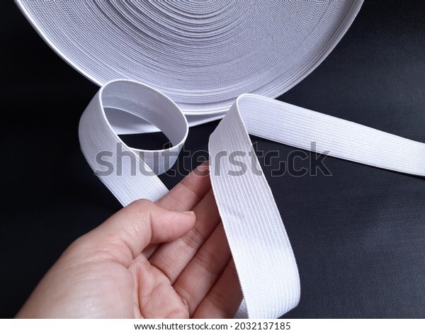 White elastic rubber\
waistband on the hand