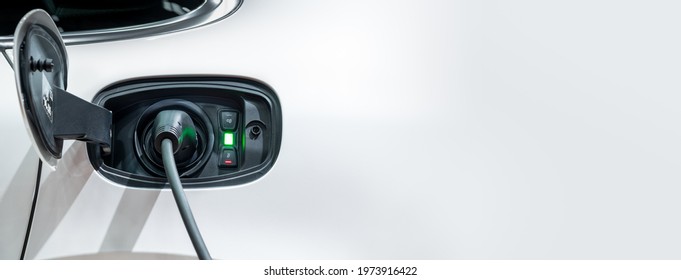 White electric car charging with copy space, Technology electric vehicle concept - Shutterstock ID 1973916422