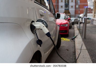 White Electric Car Charging In The Streets Of Oslo, Norway