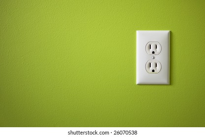 White Electric Outlet Mounted On Green Wall