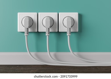 A white electrical outlet on the wall in the room. Three electric plugs with cable in the socket. - Shutterstock ID 2091733999