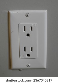 White electrical outlet socket on a wall closeup macro picture