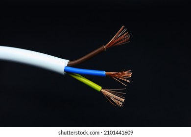 White electrical power cable macro photo. Bare copper wires are separated. Black background