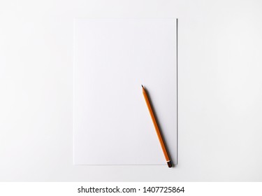 White empty A4 sheet of paper with yellow pencil isolated on white background. Place for text, advertizement banner, template paper, sample text, brochure, leaflet.