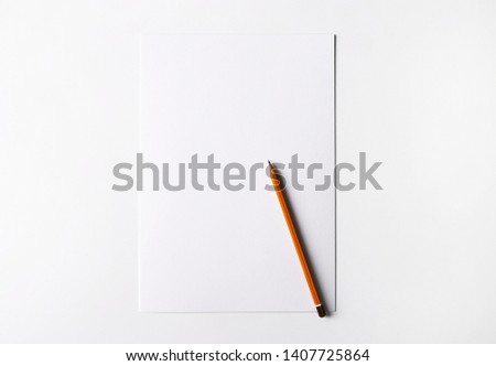 White empty A4 sheet of paper with yellow pencil isolated on white background. Place for text, advertizement banner, template paper, sample text, brochure, leaflet.