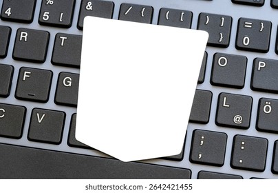 White empty blank cut out shield shaped paper sticker label cutout on modern laptop keyboard cybersecurity data protection safety online security concept information privacy, antivirus mockup template