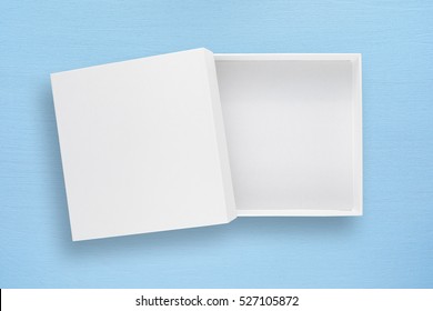 White Empty Cardboard Box With Cover On Blue Table