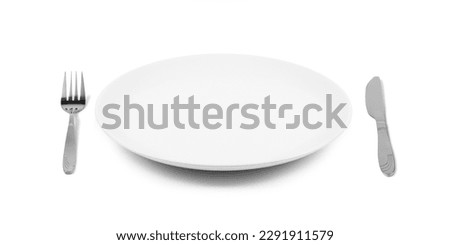 White empty ceramic plate with fork and knife, isolated on white background