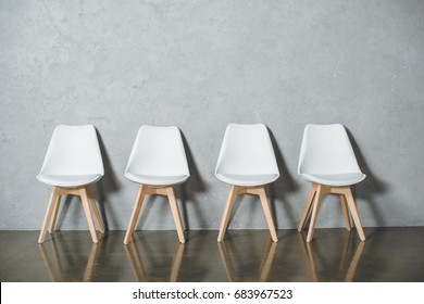 White Empty Chairs For Job Interview Standing In Line In Hall