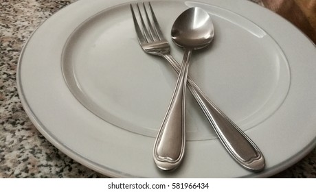 The white empty plates,spoon and fork waiting for served