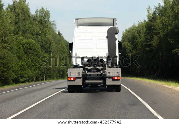 White empty\
semitrailer truck goes on the\
road
