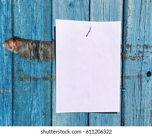 White empty sheet, hanging on the wooden board