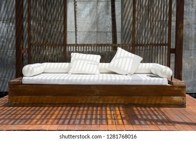 A White Empty Sofa Under A Wooden Pavillion Sun