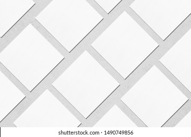 White empty square business card mockups with soft shadows lying diagonally on neutral light grey concrete background. Flat lay, top view. Open composition. - Shutterstock ID 1490749856