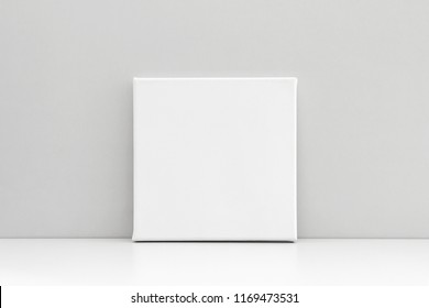 White Empty Square Canvas On Neutral Gray Background. Mock Up Poster, Canvas Template.