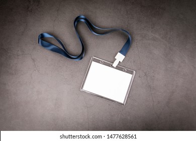 White Empty Staff Identity Mockup With Blue Lanyard. Name Tag, ID Card. Gray Concrete Background