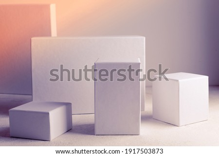 White empty stands on light background. Blank unbranded shopfront. Showcase for cosmetic products. Product advertisement. Cosmetology and beauty concept. Copy space. 